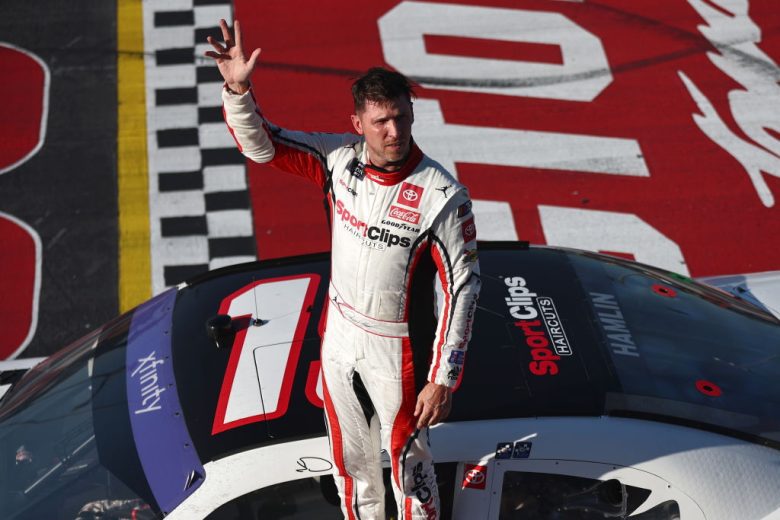 Denny Hamlin waves to the crowd following his NASCAR Xfinity Series win at Darlington Raceway.