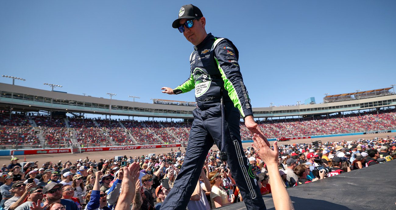 Kyle Busch walks during NASCAR Cup Series driver introductions.