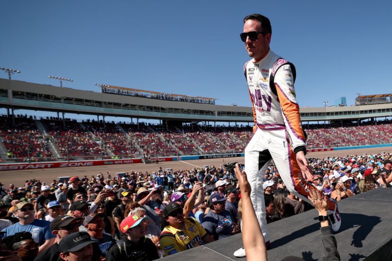 Alex Bowman walks across the stage and greets fans before a NASCAR Cup Series race at Phoenix Raceway.
