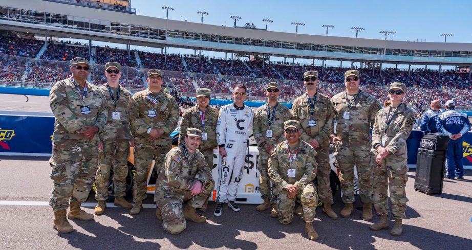 AJ Allmendinger poses for a photo with members of the United States Armed Forces at Phoenix Raceway.