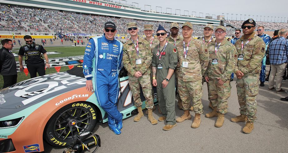 Michael McDowell poses for a photo with members of the United States Air Force