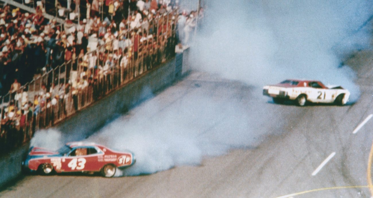 David Pearson driver of the No. 21 Wood Brothers Mercury and Richard Petty driver of the No. 43 STP Dodge crash during the 1976 Daytona 500 at the Daytona International Speedway on February 15, 1976 in Daytona Beach, Florida.