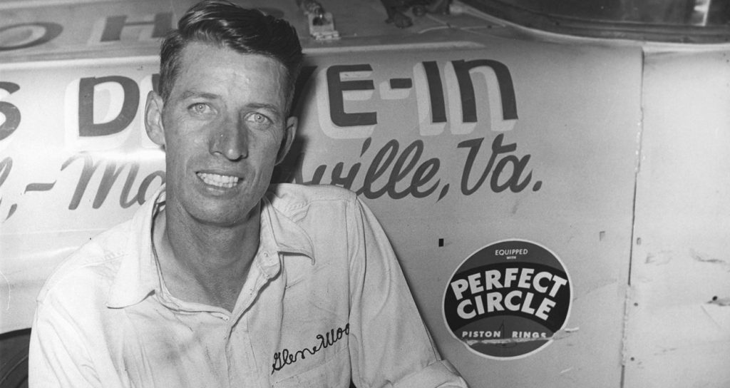 Glen Wood poses with one of his NASCAR Cup cars in the mid-1950s. As a driver, Wood raced on the NASCAR Cup and Convertible circuits from 1953 through 1964. He won four Cup races and five times on the Convertible circuit. 
