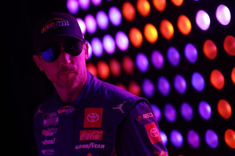 Denny Hamlin, reflected in the bright lights of driver introductions at Las Vegas Motor Speedway