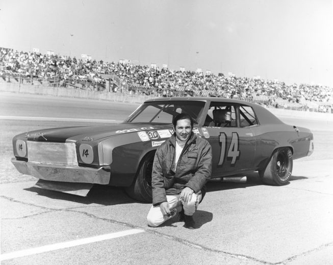 Pedro Rodriguez poses next to car at Daytona.