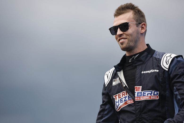 Daniil Kvyat smiles and looks on.