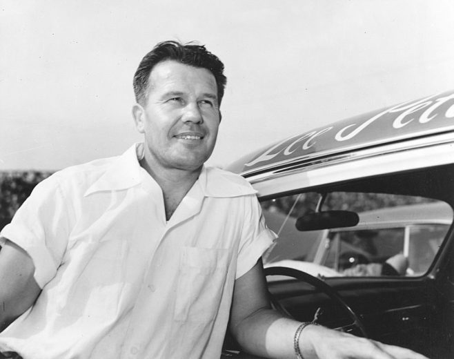 Lee Petty looks on.
