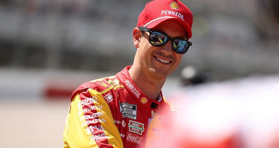Joey Logano smiles as he waits on the Cup Series grid at Darlington Raceway
