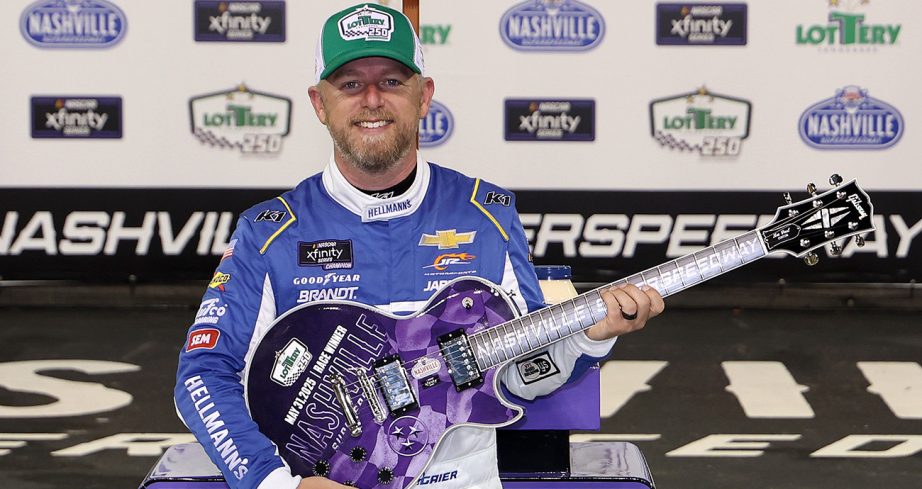 Justin Allgaier stands in Victory Lane at Nashville Superspeedway.