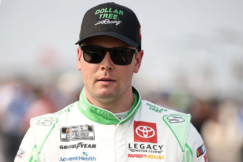 Erik Jones looks on.