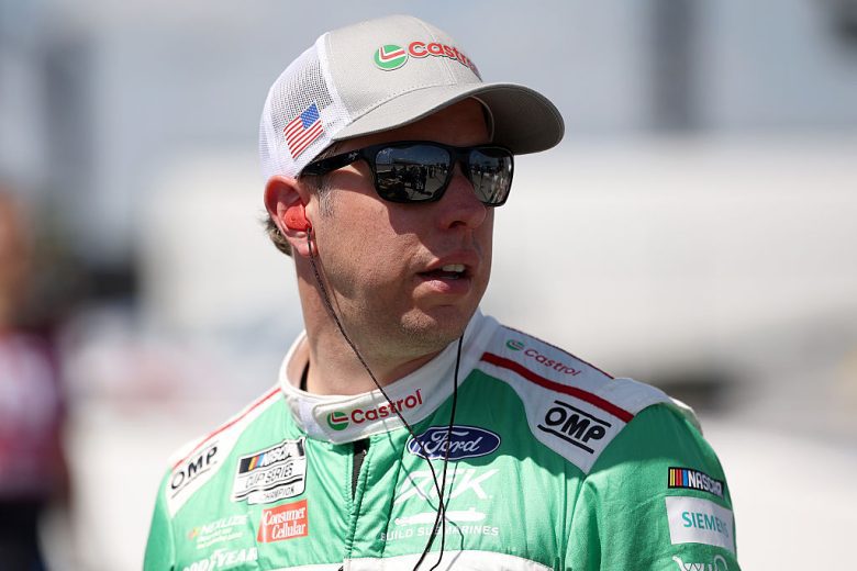 Brad Keselowski looks on.
