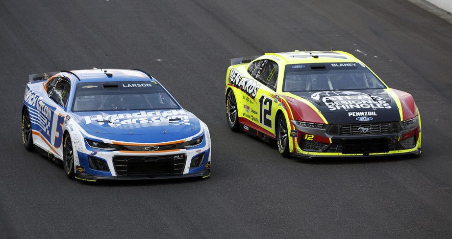 Ryan Blaney races alongside Kyle Larson at Indianapolis Motor Speedway.