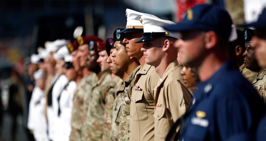 service members stand before a nascar cup series race at charlotte motor speedway