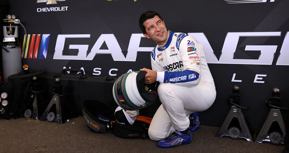 Mike Rockenfeller looks on and smiles in Garage 56 firesuit.