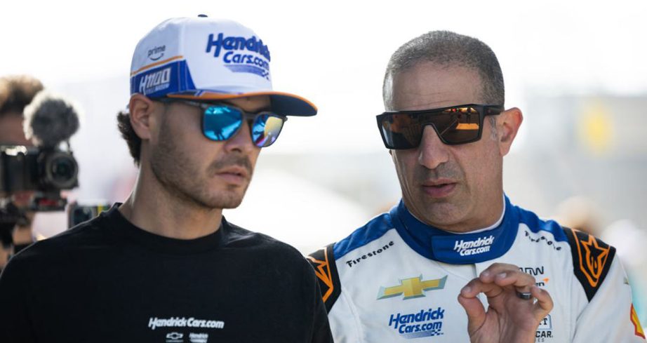 Tony Kanaan talks with Kyle Larson during practice at Indianapolis Motor Speedway.