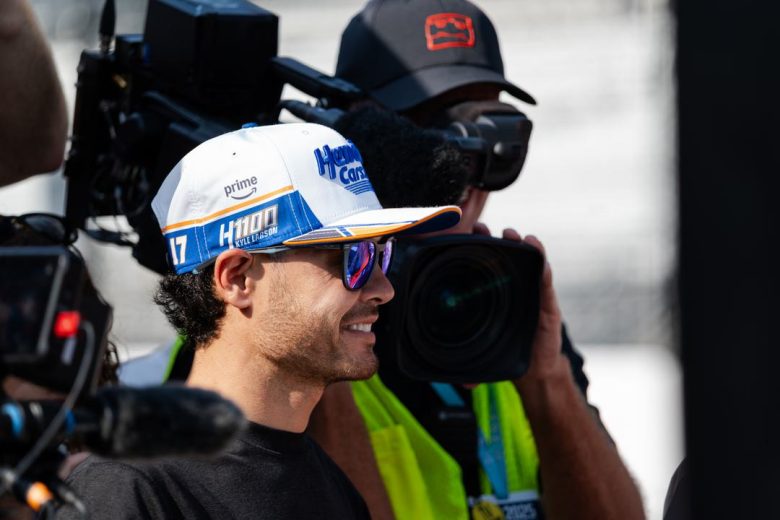 Kyle Larson looks on and smiles during practice at Indianapolis Motor Speedway.