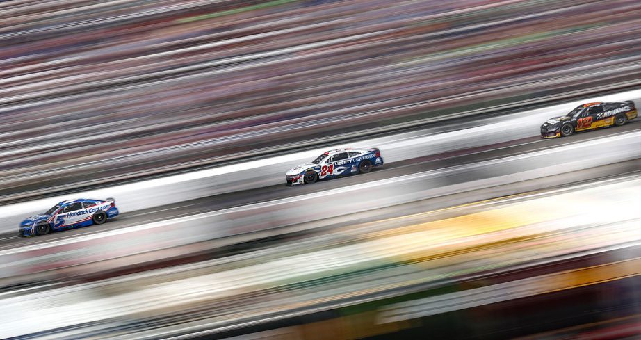 Kyle Larson leads William Byron and Ryan Blaney at track.