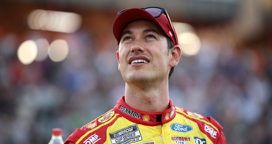 Joey Logano looks on and smiles.