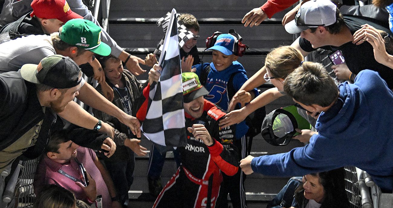 CONCORD, NORTH CAROLINA - MAY 29: Ryan Blaney, driver of the #12 BodyArmor Cherry Lime Ford, celebrates with fans after winning the NASCAR Cup Series Coca-Cola 600 at Charlotte Motor Speedway on May 29, 2023 in Concord, North Carolina. (Photo by Logan Riely/Getty Images)