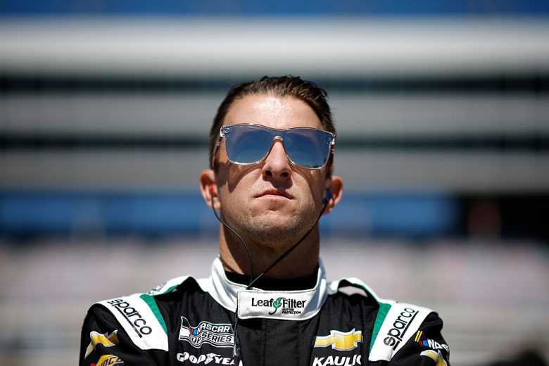 AJ Allmendinger looks on.