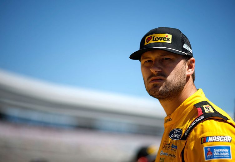 Todd Gilliland looks on.