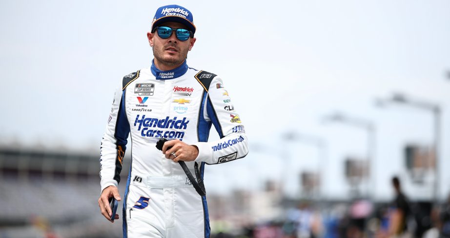 Kyle Larson jogs on the grid during qualifying for the NASCAR Cup Series Coca-Cola 600 at Charlotte Motor Speedway.