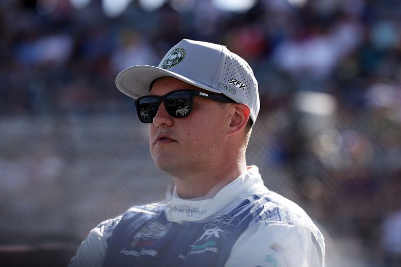 Ryan Preece looks on.
