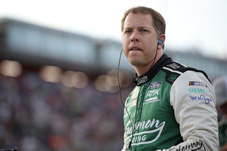 Brad Keselowski looks on.