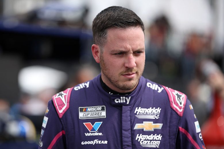 Alex Bowman looks on.