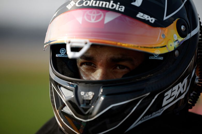 Bubba Wallace looks on.