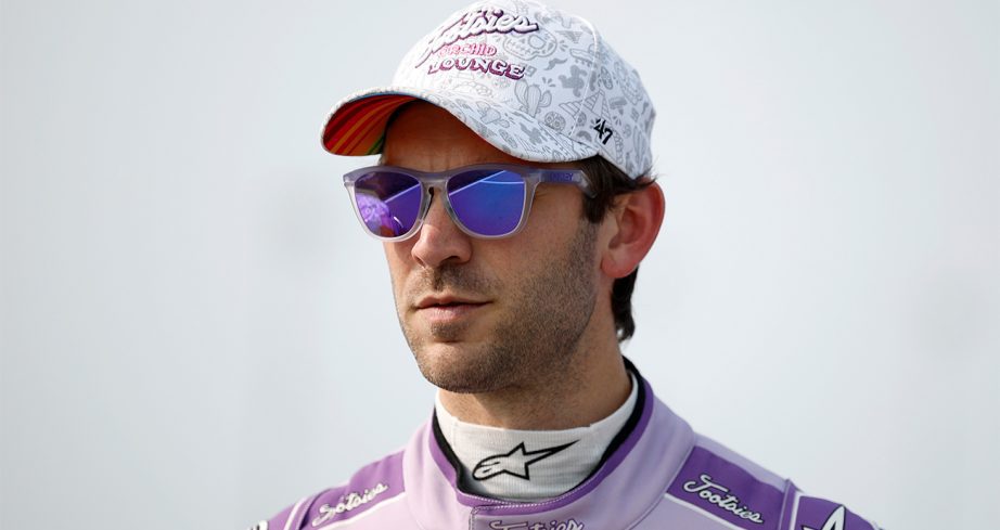 Daniel Suárez looks on.