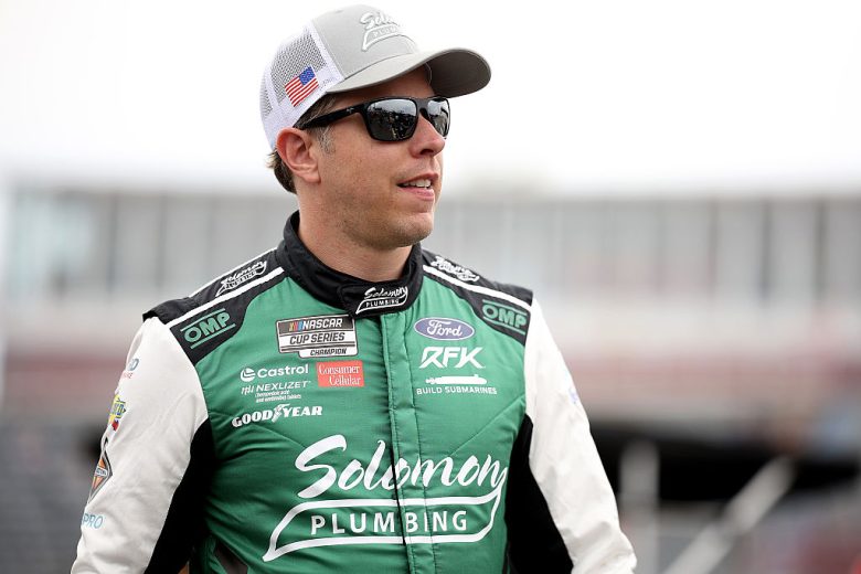 Brad Keselowski looks on.
