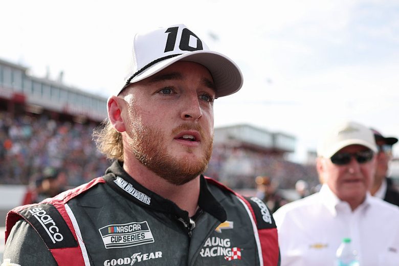 Ty Dillon looks on.