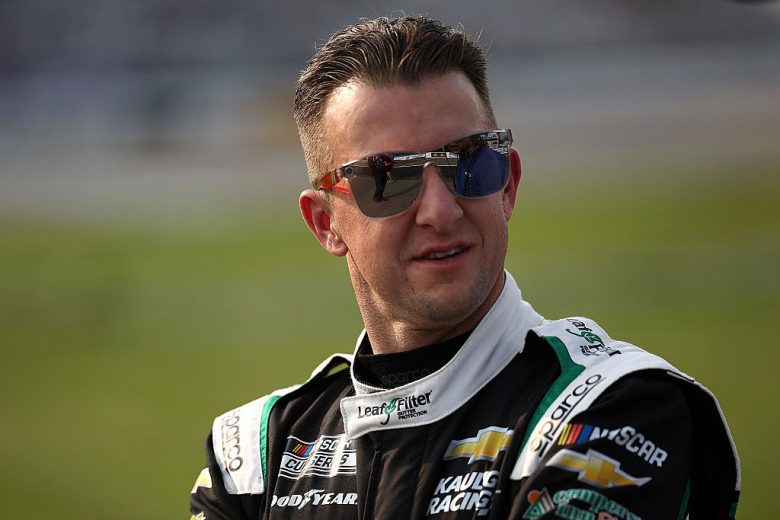 AJ Allmendinger looks on.
