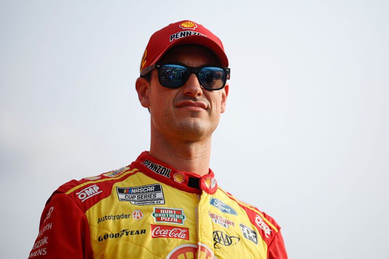 Joey Logano looks on.