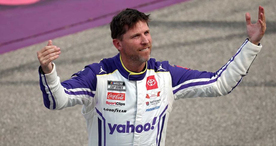 Denny Hamlin gestures to the crowd after winning at Michigan International Speedway