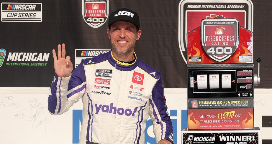 Denny Hamlin stands in Victory Lane at Michigan.