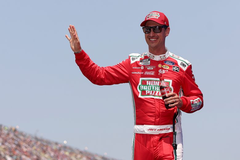 Joey Logano waves to the crowd before a NASCAR Cup Series race.