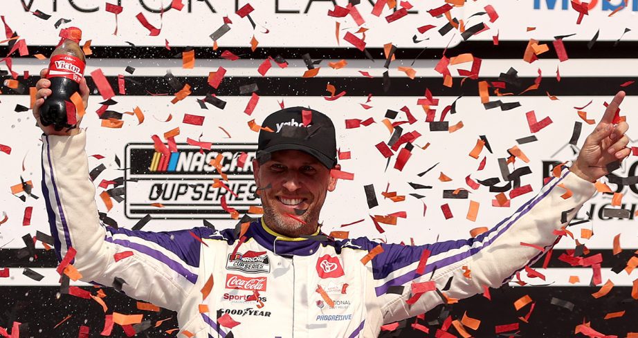 denny hamlin celebrates his nascar cup series win at michigan in 2025