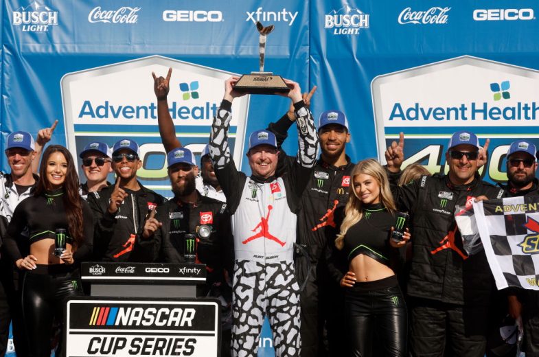 Kurt Busch celebrates with his team in Victory Lane following his NASCAR Cup Series win at Kansas Speedway.