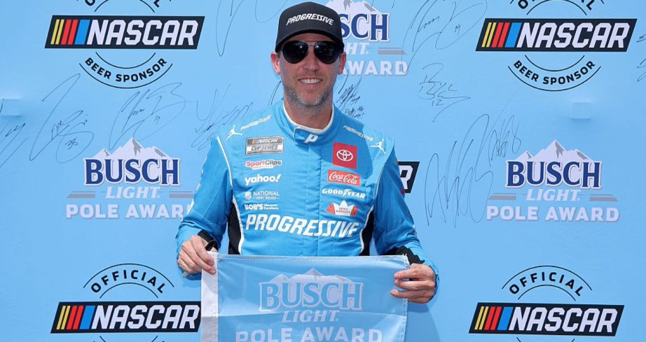 Denny Hamlin celebrates after winning the pole at Pocono.
