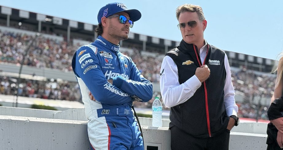 Kyle Larson talks with Jeff Gordon on pit road at Pocono Raceway.