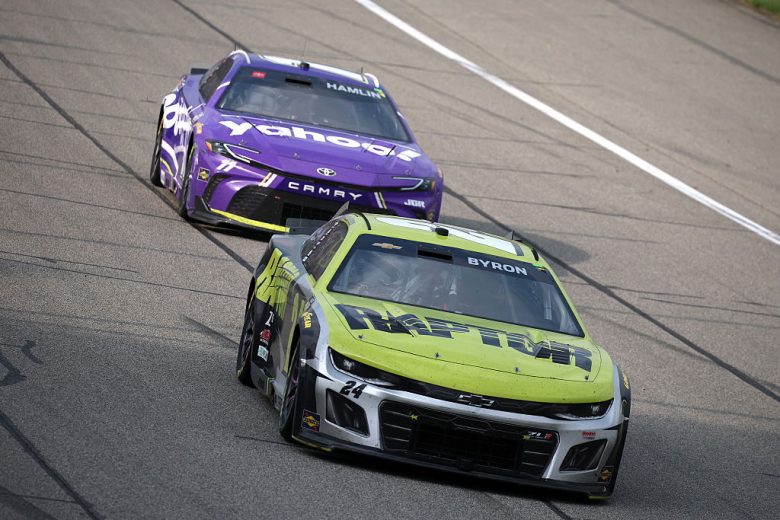 William Byron, in the No. 24 Hendrick Motorsports Chevrolet, races ahead of Denny Hamlin's No. 11 Joe Gibbs Racing Toyota during a NASCAR Cup Series race.