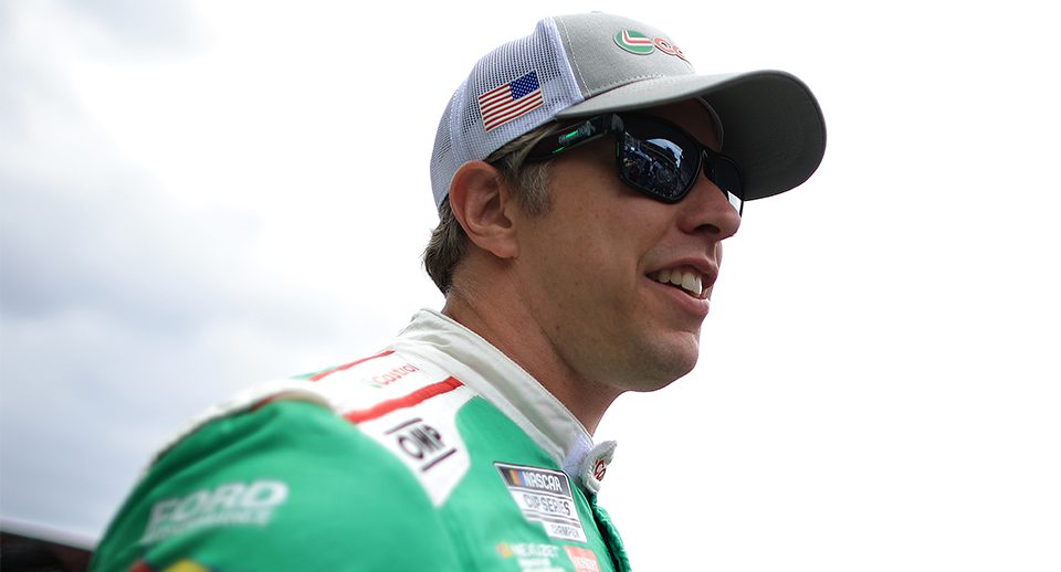 brad keselowski looks on, smiling