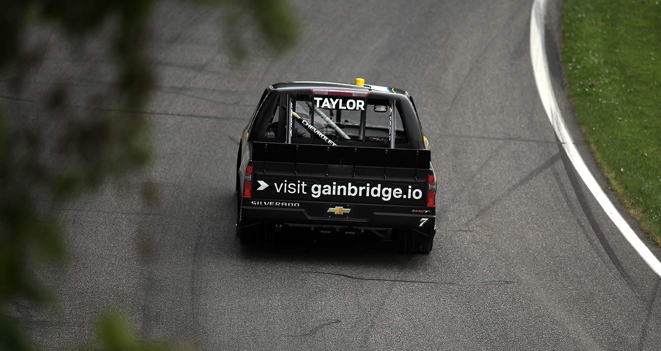 Jordan Taylor rounds a turn at Lime Rock Park in the No. 7 Chevrolet