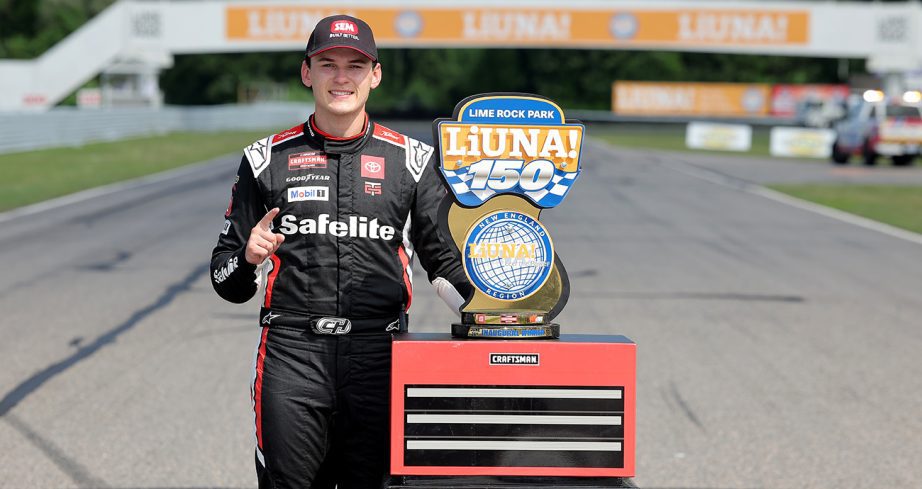 Corey Heim stands in Victory Lane with the trophy at Lime Rock Park.