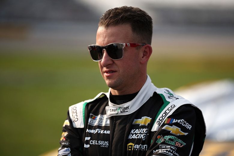AJ Allmendinger looks on.