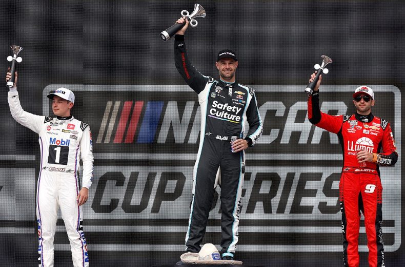 Christopher Bell (L), Shane van Gisbergen (C) and Chase Elliott (R) pose on the podium following a NASCAR Cup Series race in Mexico City.