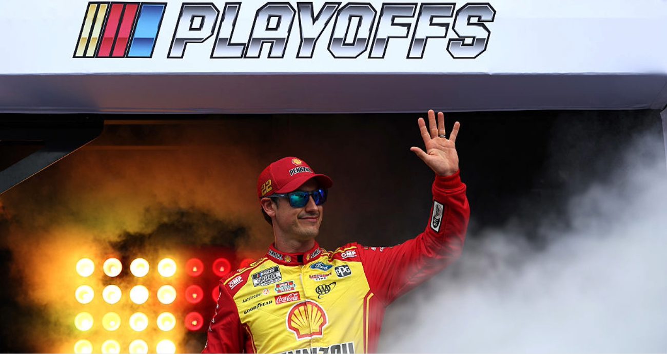 Joey Logano looks on.