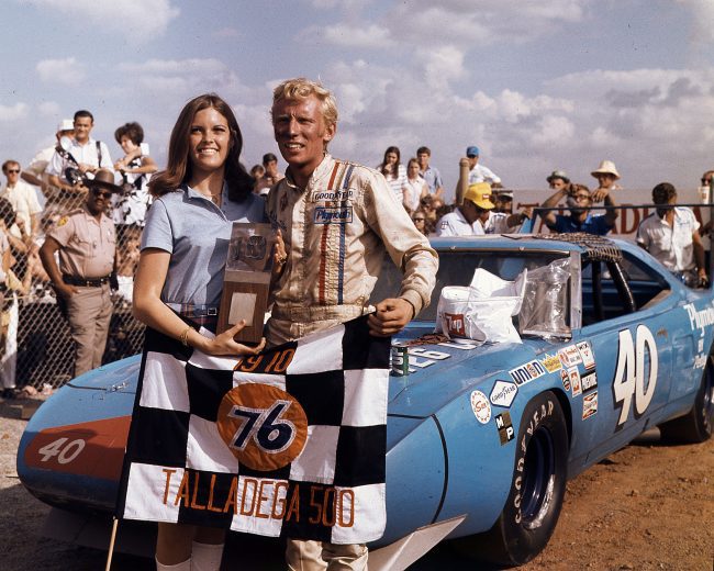 Pete Hamlilton poses in Victory Lane with car and trophy at Talladega.